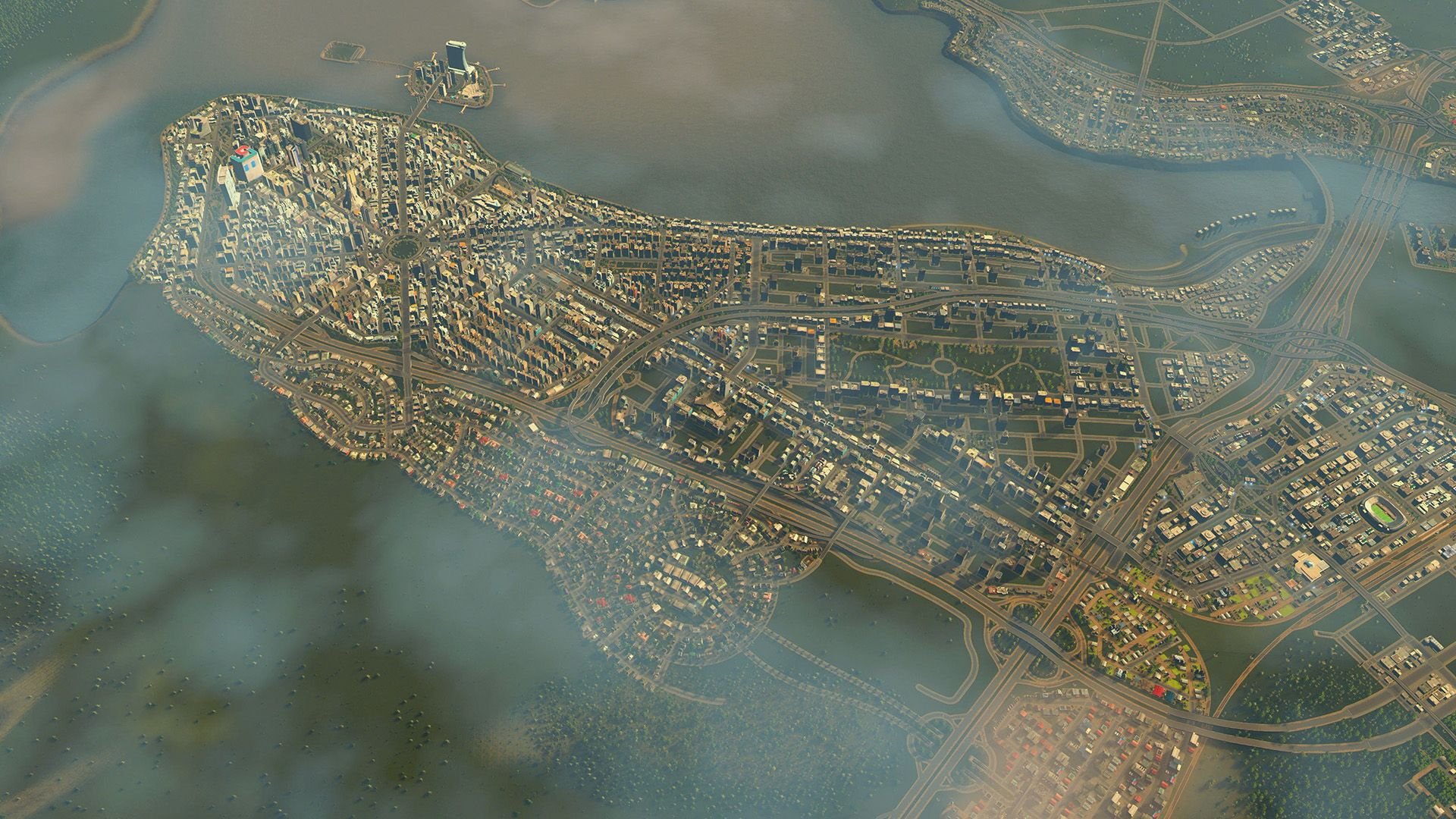 An aerial view of the city built along a peninsula that is presently shrouded in fog.