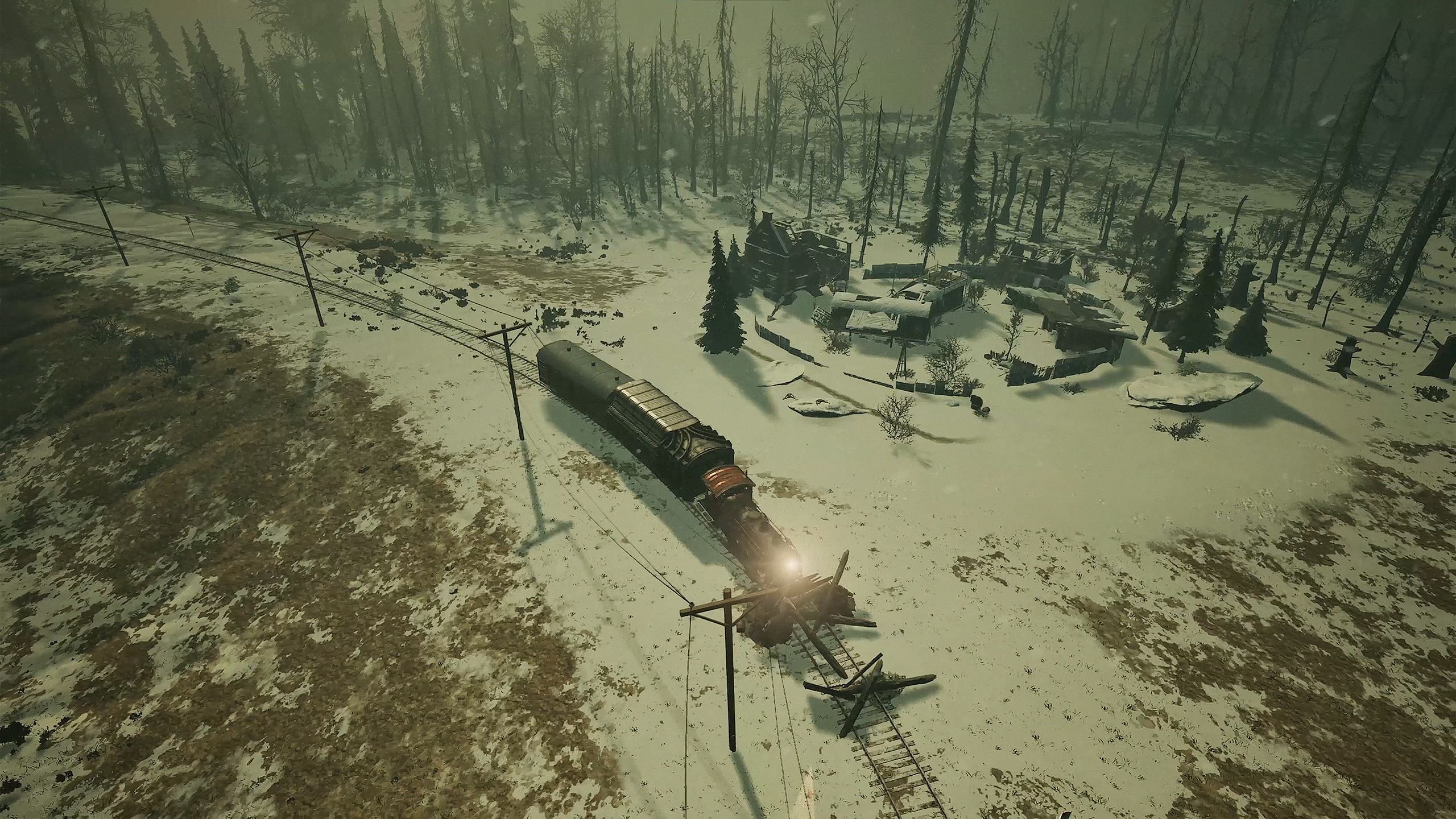 A distant view of a train arriving at twin blockades lain across the track in a snowy wasteland.