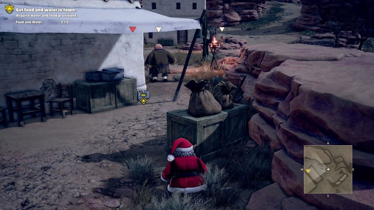Crouching in a Santa suit, near some rocks, and looking past some crates at the back of a posted guard.