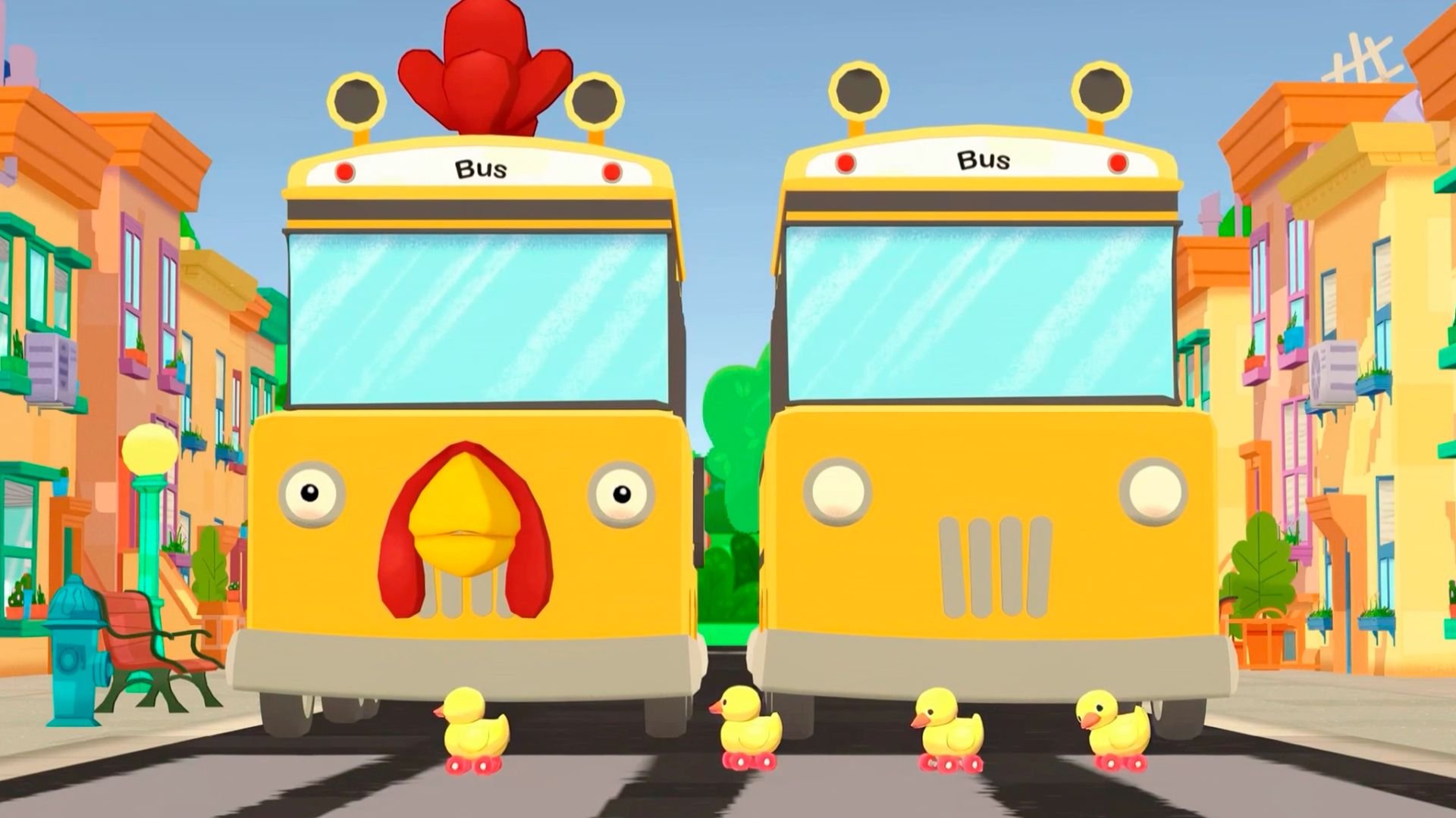 Ducks on wheels roll in front of two busses, one of which looks vaguely like a chicken.