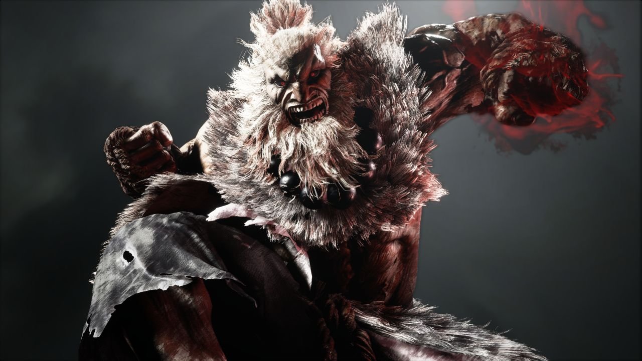 A closeup of a bearded Akuma, looking all grizzly, as he prepares to punch the screen with a glowing red fist.