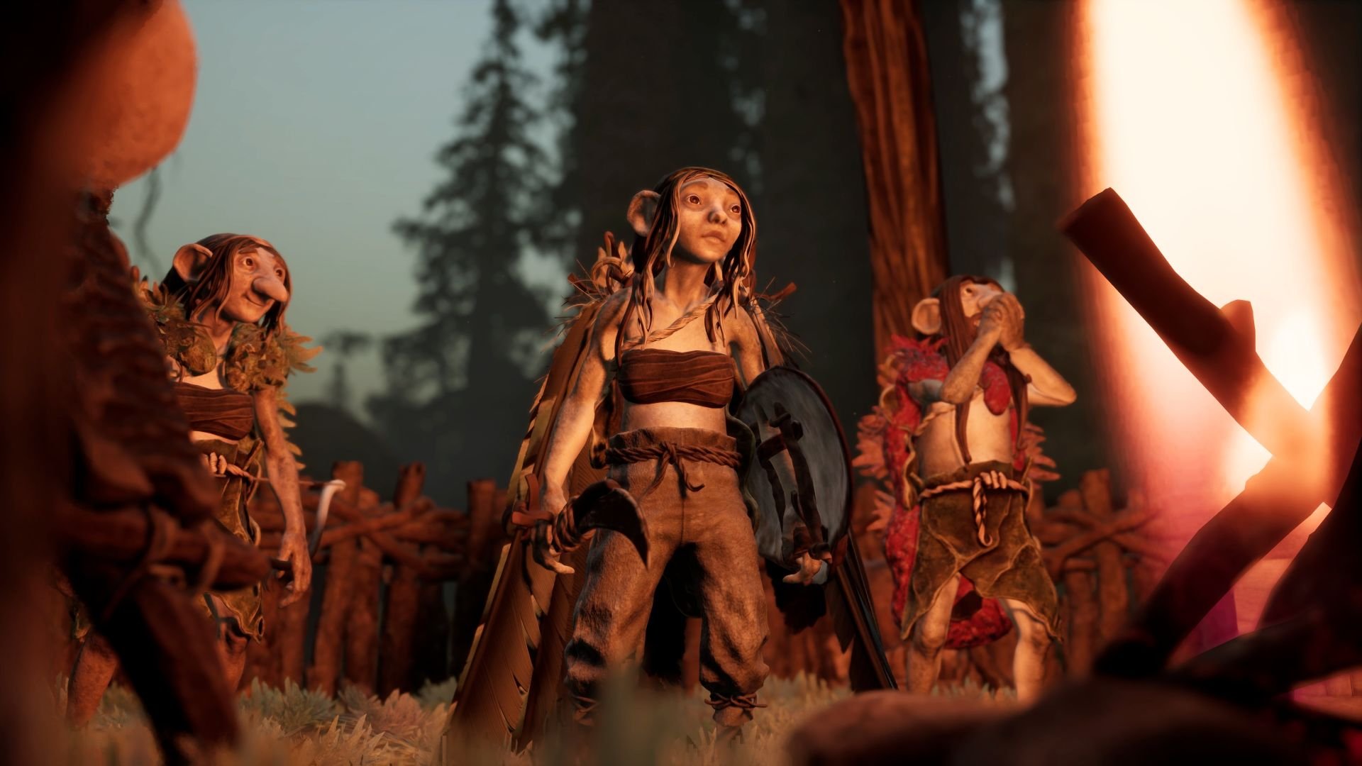 Several gnome characters stand facing a burning fire at dusk, dressed for battle.