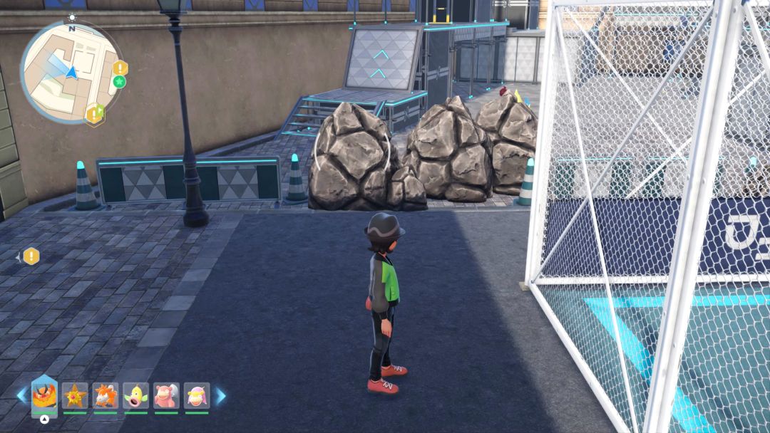 The Pokemon Trainer faces a series of boulders that block his path to some scaffolding near the outside training grounds.