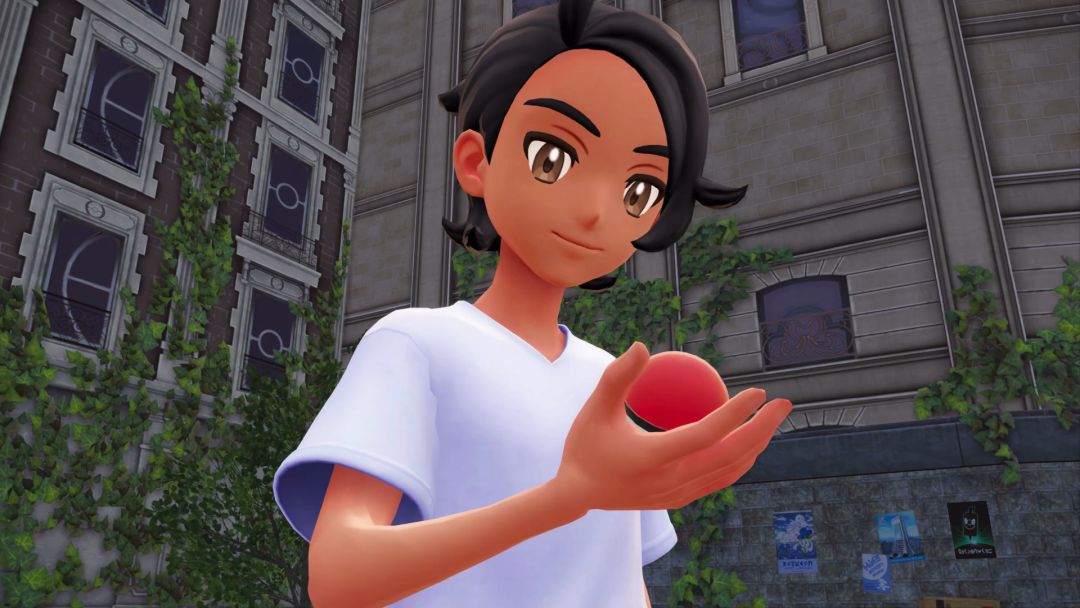 In closeup, the player Pokemon Trainer looks down at the Poke Ball he received as a reward for defeating Pancham.