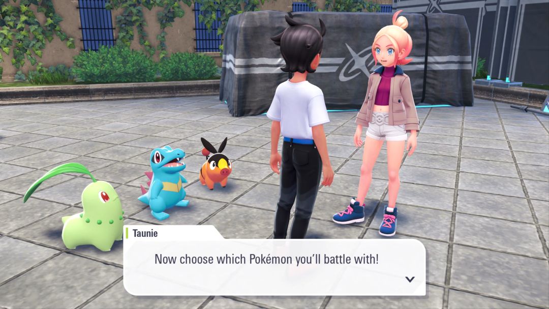 As Tepig, Totodile, and Chekorita watch, Taunie invites you to choose one of them to serve as your starting Pokemon.