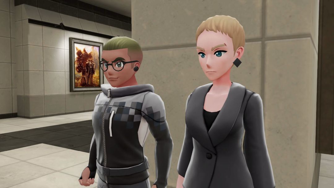 Lumios Museum's curators, Bundo and Wanda, stand in front of a stone column on the ground floor.