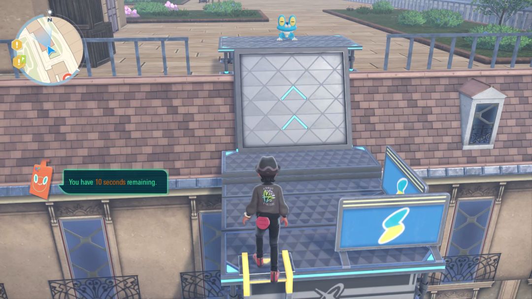 Near the very top of the first scaffolding course, the Pokemon trainer reaches the top of the ladder and turns toward the waiting Froakie.