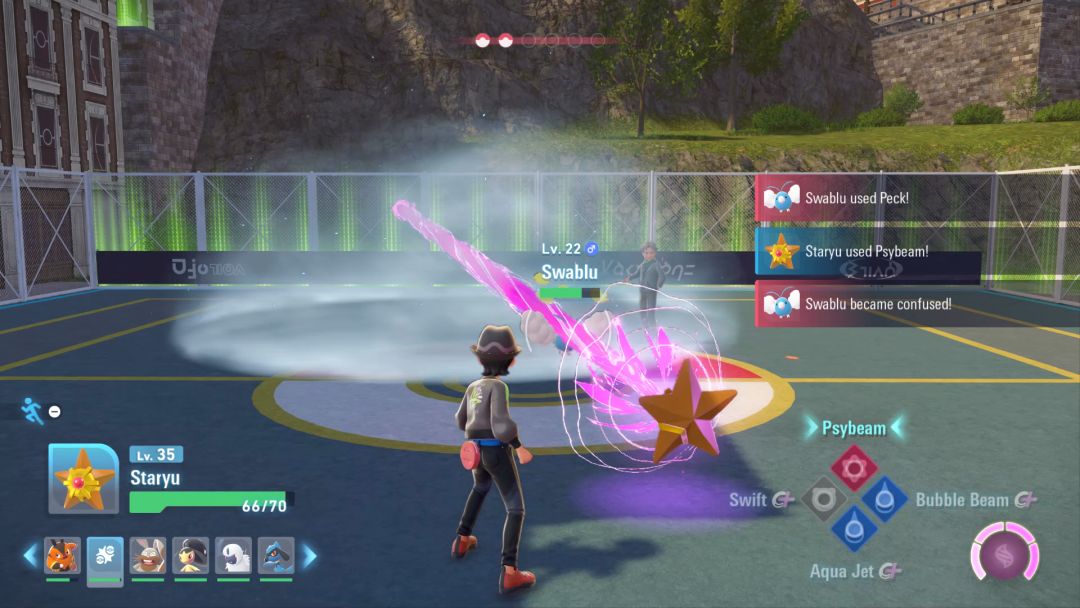 Staryu launches a purple beam at a Swablu who has just emerged from some mist in the outdoor Pokemon battle arena.