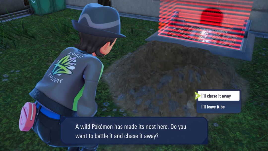 The Pokemon Trainer kneels down ahead of a pile of dirt at the base of a broken Holovator and decides to chase away a Pokemon.