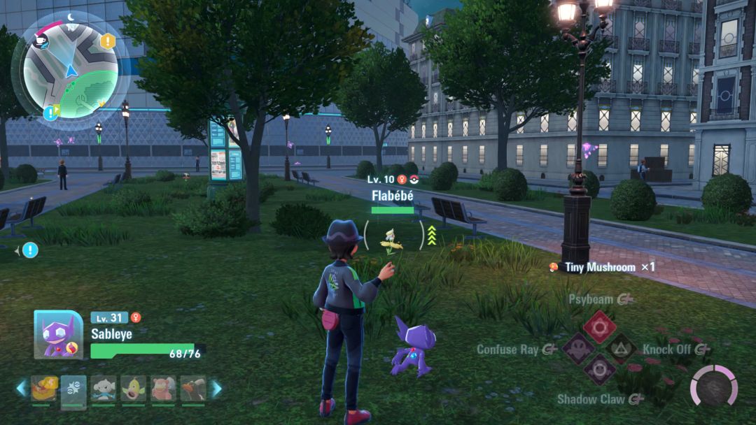 The Pokemon Trainer stands in some grass along Vert Street, looking toward a yellow Flabebe that is drifting through some taller grass ahead.