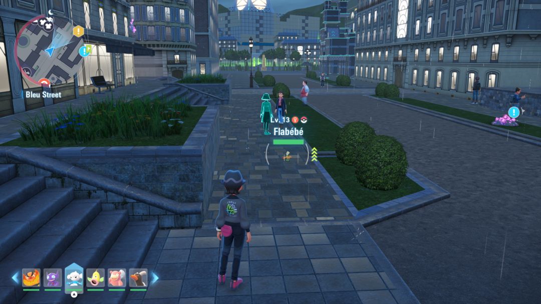 The Pokemon Trainer heads north on Bleu Street, keeping to the left to find an orange Flabebe among the bushes.