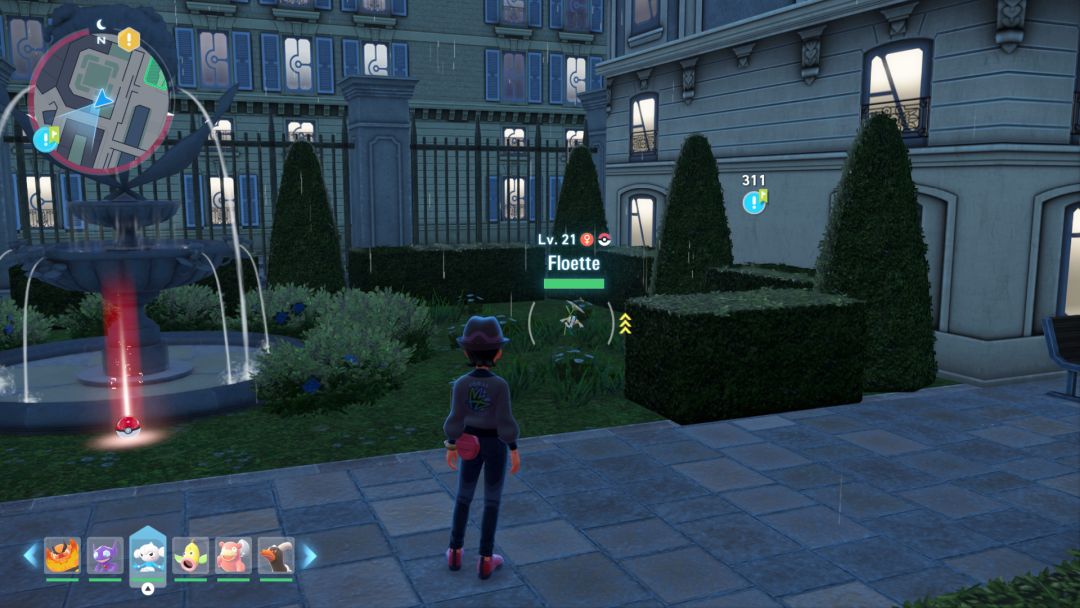 A white Flabebe hides among the shrubbery in Vert Sector 3 as a Pokemon Trainer prepares to toss a Poke Ball at it.