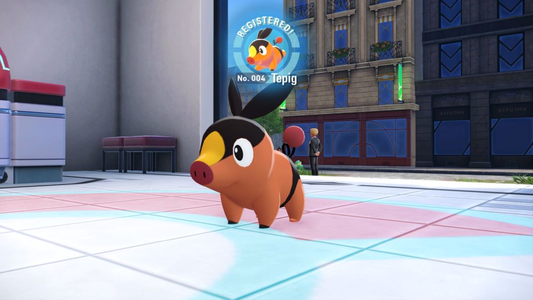 A closeup of Tepig, with a stamp near the top center of the screen indicating Tepig has been registered to the Pokedex.