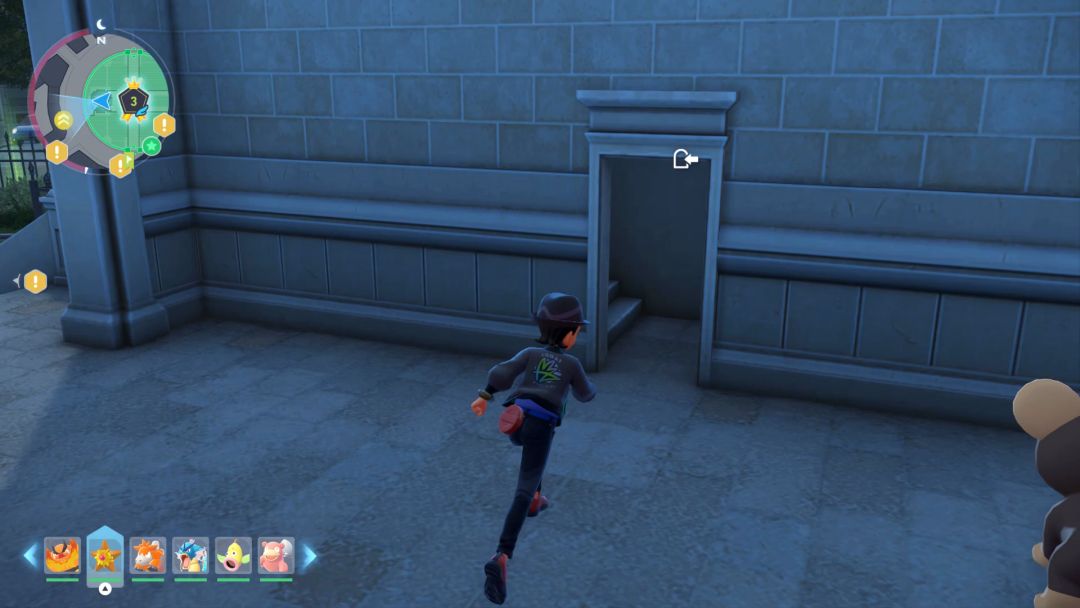 Inside the gray building in Wild Zone 3, the Pokemon Trainer heads toward an open door and staircase along the back wall.