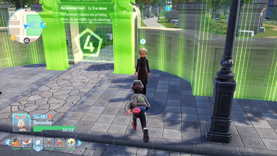 The Pokemon Trainer runs toward Moire, who stands to the right of the gate leading into the graveyard where she lost her ring.