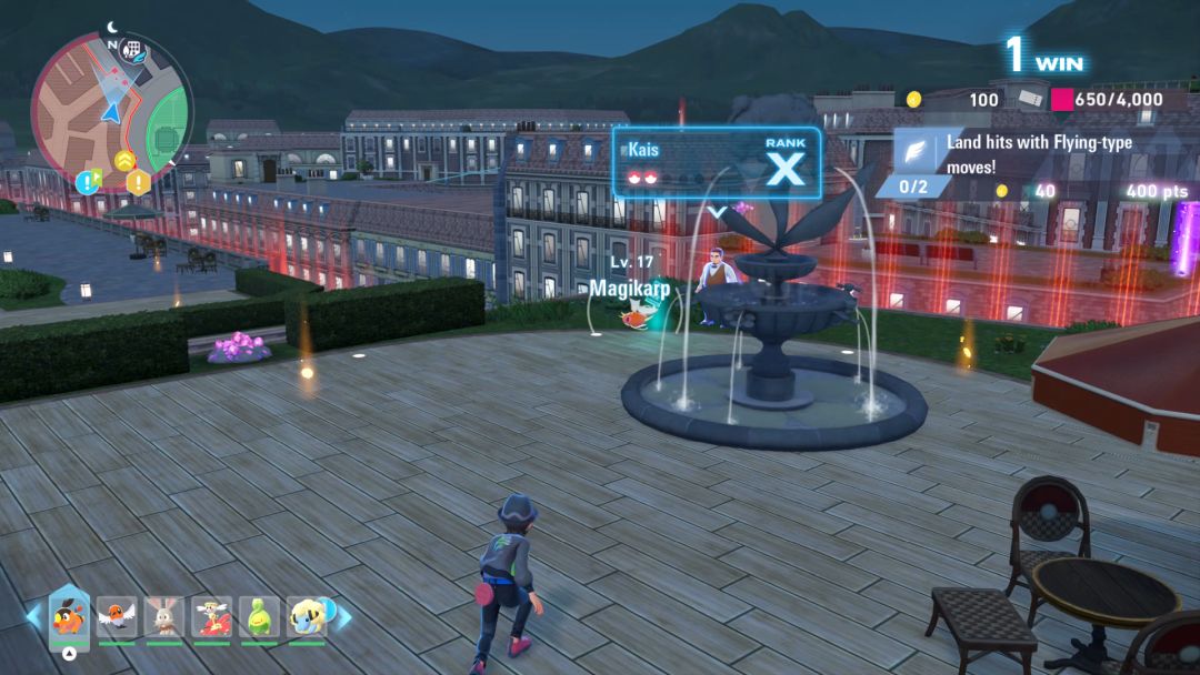 The Pokemon Trainer sneaks toward a rival trainer, who is standing near a rooftop fountain with his Magikarp visible.